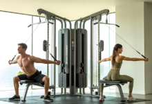 A modern home gym setup featuring a dual adjustable pulley machine.